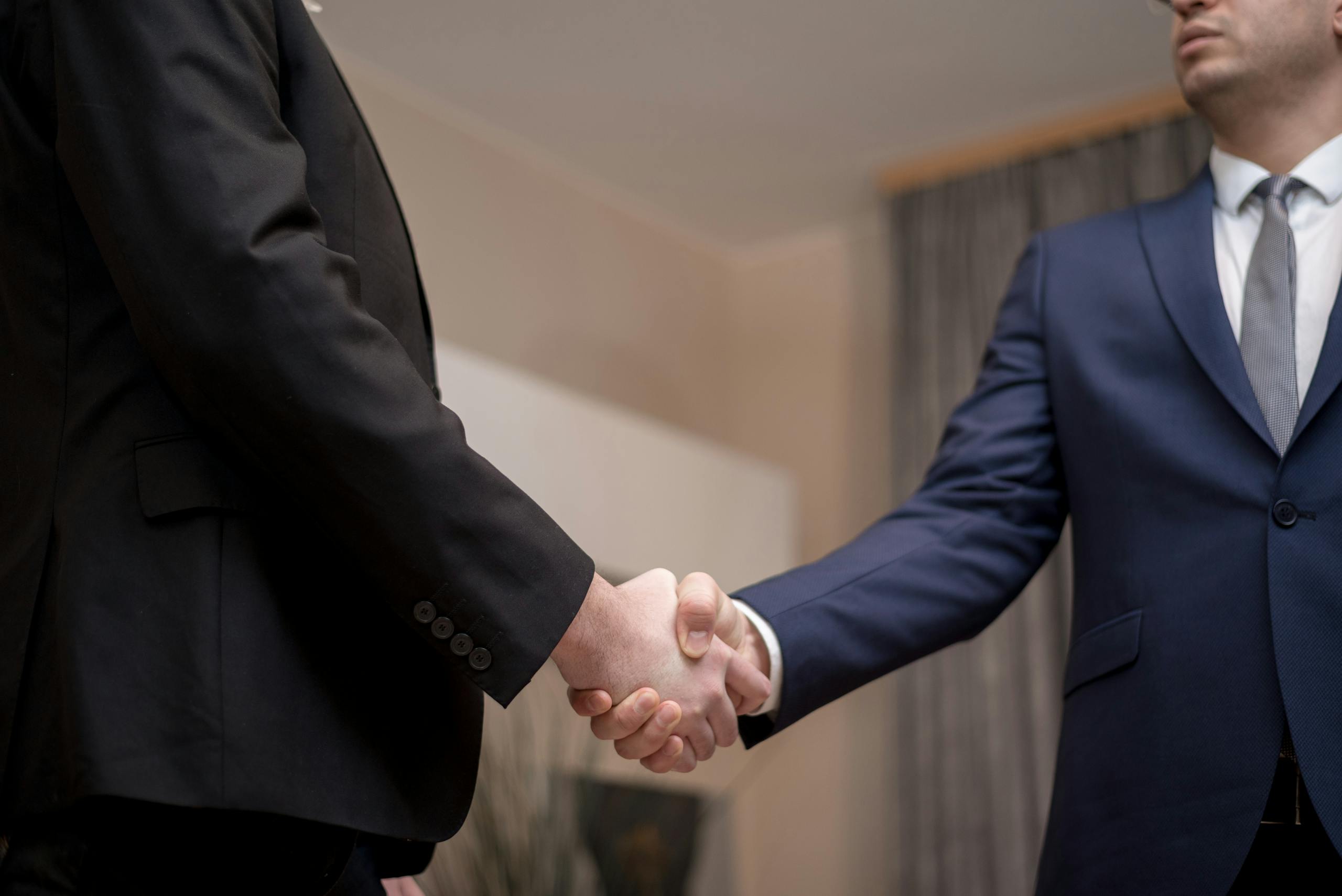 Men in Black and Blue Suit Jacket Doing Handshake